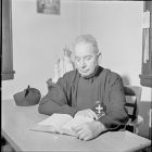 Father Maurice studying